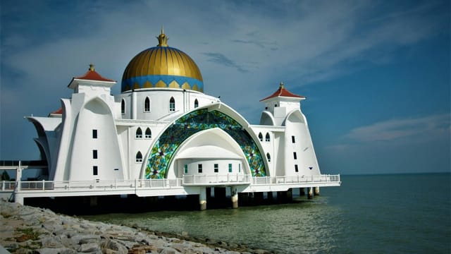 Beautiful shot of Malacca Straits Mosque with its golden dome and seaside location.