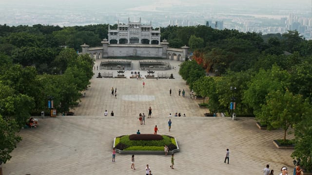 Aerial view of the Sun Yat-sen Mausoleum in Nanjing with tourists exploring the scenic park.