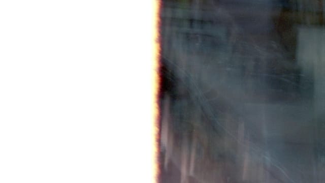 Abstract image capturing light leaks and textures from the end of a film roll.