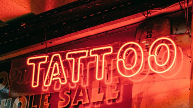 Vibrant neon tattoo sign glowing in the night in Istanbul.