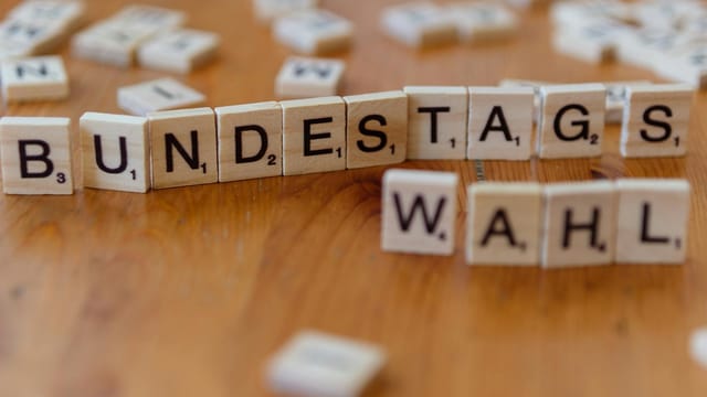 Scrabble tiles spelling 'Bundestagswahl', symbolizing German election themes.
