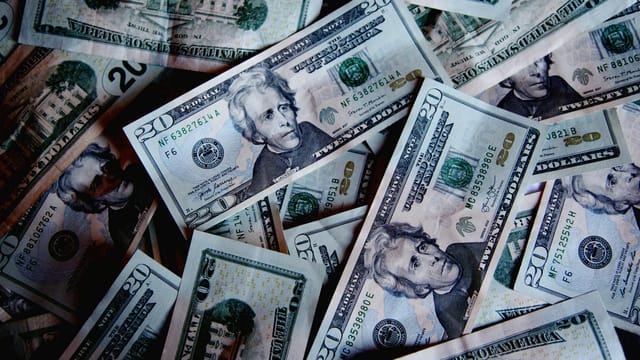 A stack of US dollar bills symbolizing wealth, finance, and abundance.