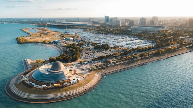 Stunning aerial view of a lakeside cityscape with a prominent dome structure.