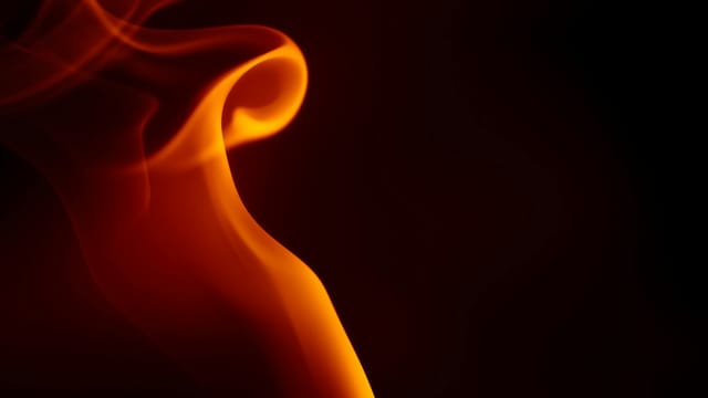 Dynamic abstract image of a flame with smooth, swirling curves and a warm orange glow.