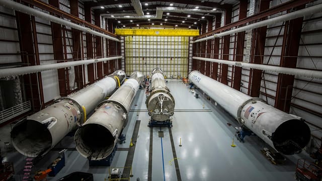 Various huge metal details and fragments of unfinished rocket located in contemporary assembly factory