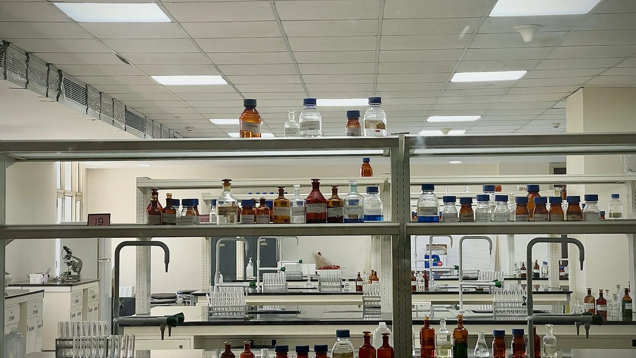A detailed view of a modern science lab with chemical bottles and test tubes.