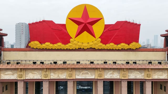 A vibrant red star adorns a building's facade, symbolizing historical significance in Nanchang, China.