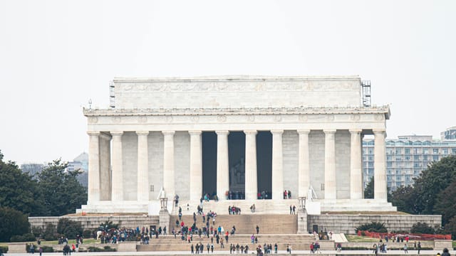 The iconic Lincoln Memorial surrounded by tourists on a day visit in Washington, DC.