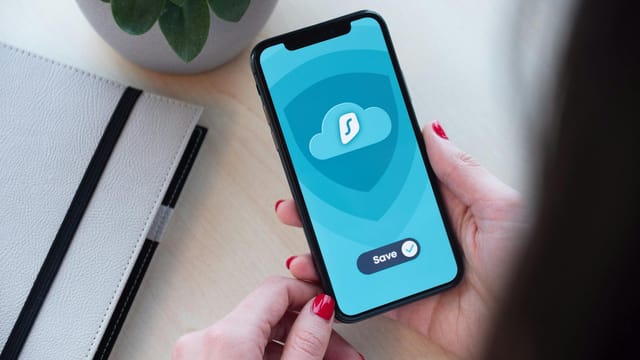 Woman using a secure mobile app, showcasing data encryption on a smartphone.