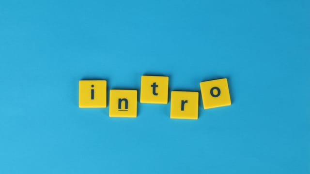 Yellow letter tiles spell 'intro' on a vibrant blue background, ideal for creative projects.