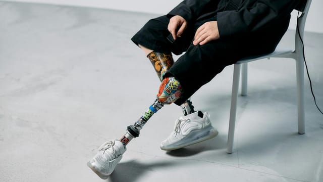 Colorful prosthetic legs in a minimalist studio, showcasing innovation and technology.