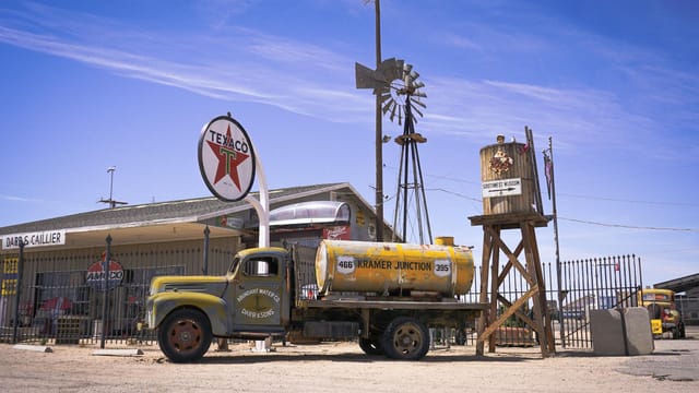 Iconic vintage Texaco gas station at Kramer Junction, featuring an old tanker truck and windmill.