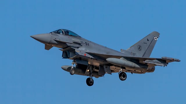 Eurofighter Typhoon jet in flight against clear blue sky at Los Llanos, Spain.