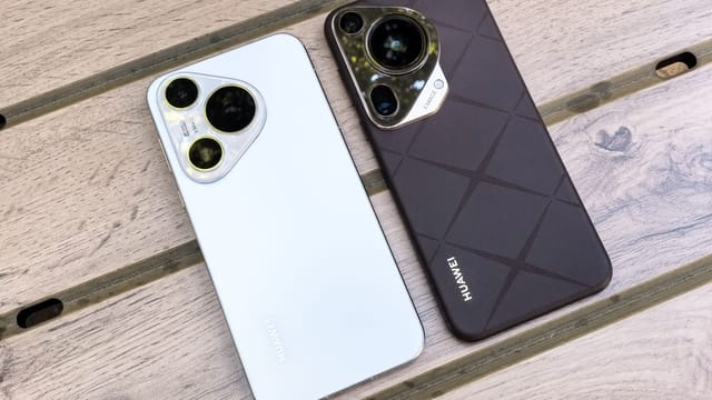 Two modern smartphones displayed on a wooden surface, showcasing sleek design and camera features.