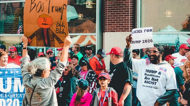 Protest and support dynamic at a political rally in Wheeling, West Virginia.