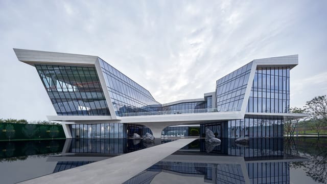 Contemporary building with reflective glass facade in Sichuan blending nature and innovation.