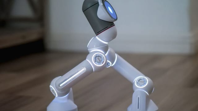 Side view of a modern robot walking on a wooden surface, showcasing advanced technology.