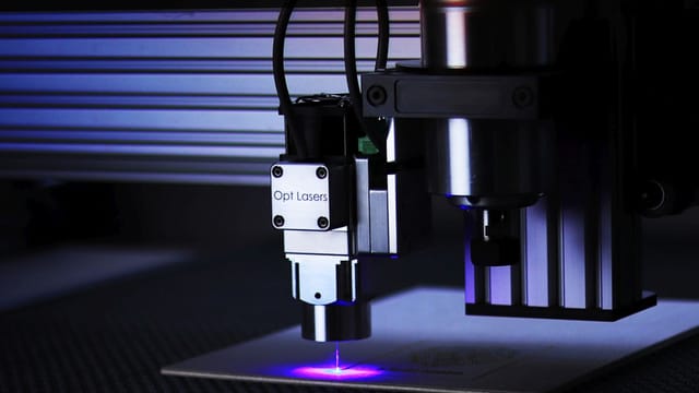 Close-up of cutting-edge laser engraving machine in a precision manufacturing process.