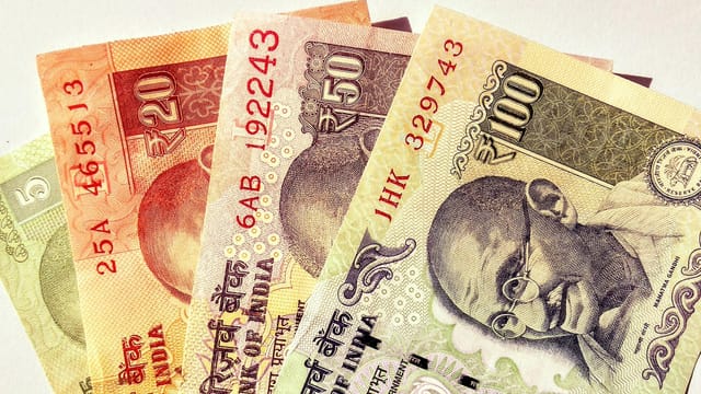 Close-up image of Indian rupee banknotes in various denominations, showcasing currency design.