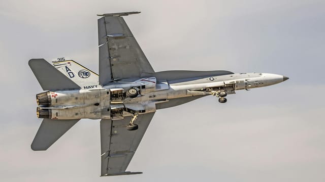 Dynamic view of an F/A-18 Hornet jet showcasing military aviation excellence over Florida.