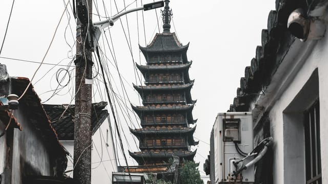 Beisi Pagoda in Suzhou, China captured amidst urban elements and local architecture.