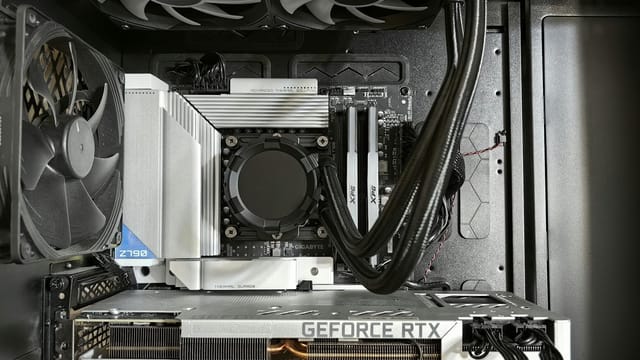 Detailed view of a custom gaming PC's interior showcasing components like RTX GPU and advanced cooling system.