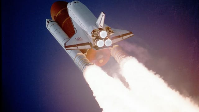 A space shuttle launches into space, showcasing powerful rocket engines and USA branding.