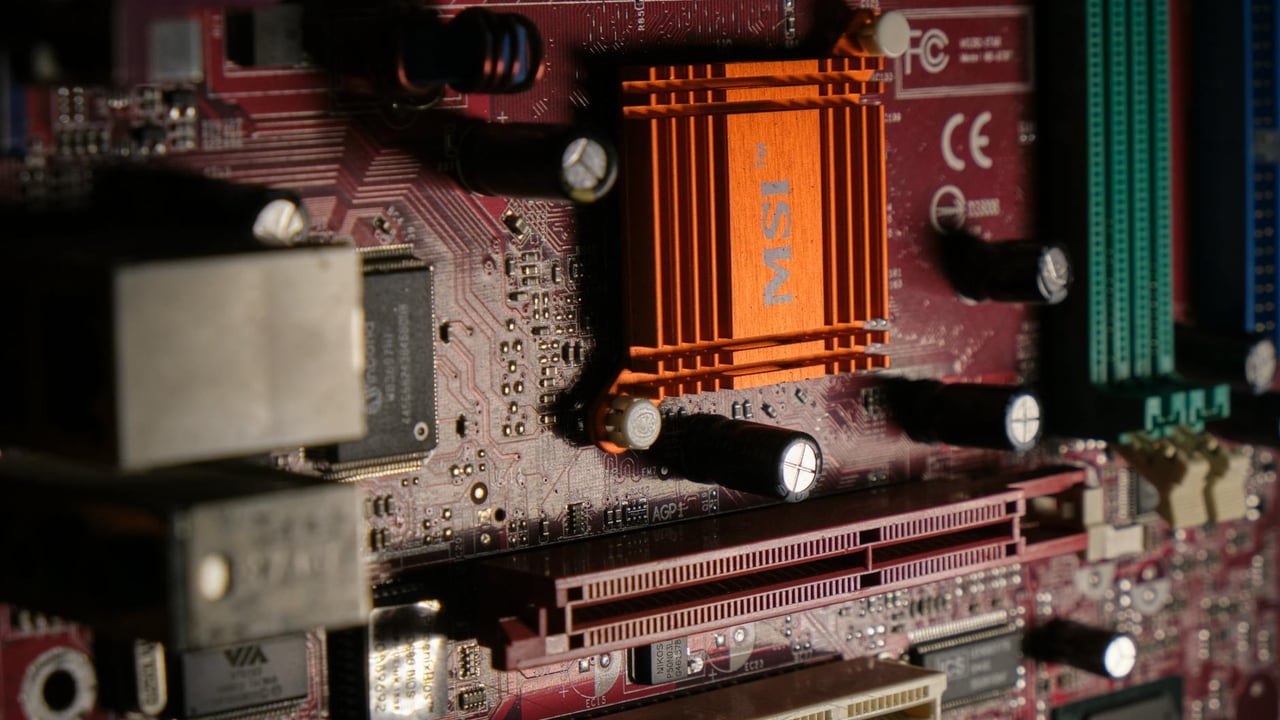 Detailed view of a computer motherboard showcasing intricate electronic components.