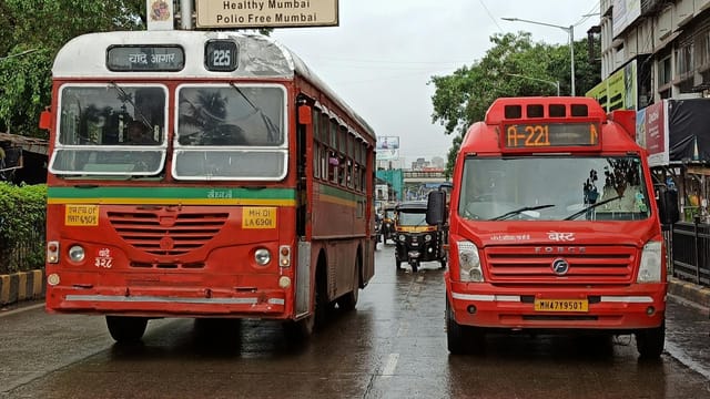 Buses and auto-rickshaws on a rainy Mumbai street, India.