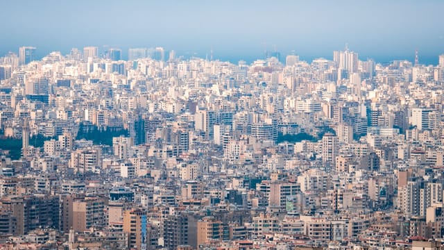 Expansive aerial view showcasing Beirut's dense urban architecture under a clear sky.