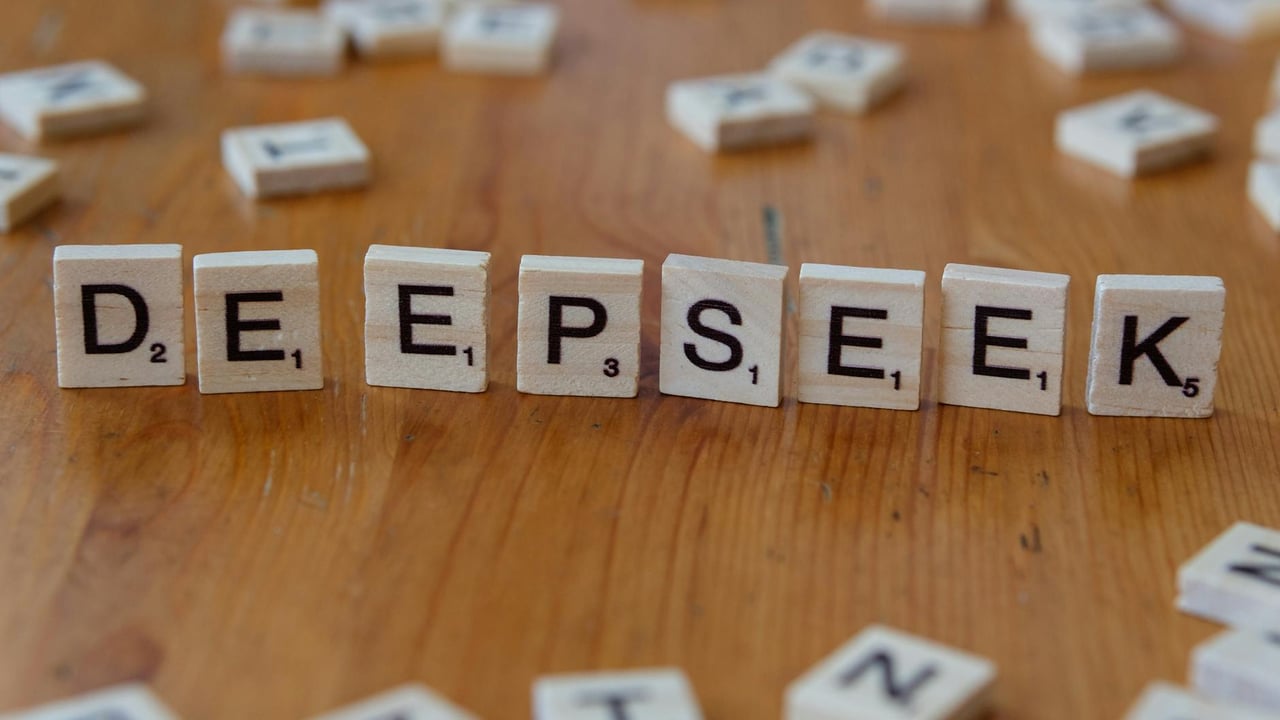 Scrabble tiles spelling 'DeepSeek' on a wooden surface. Perfect for AI and tech themes.
