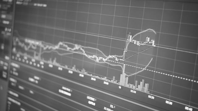 Black and white display of financial chart with data and statistics for trading analysis.
