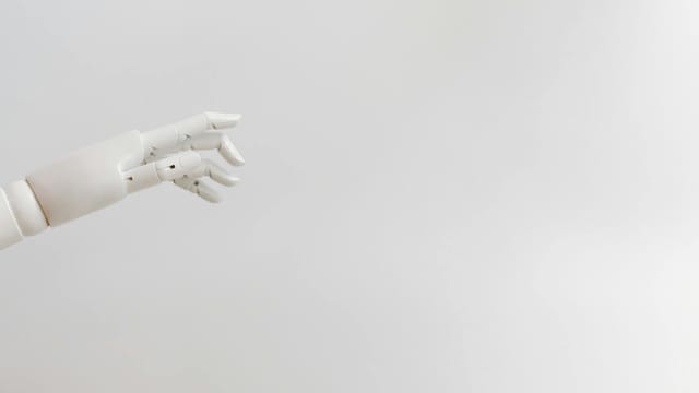 Minimalist image of a robotic hand reaching out on a white background.