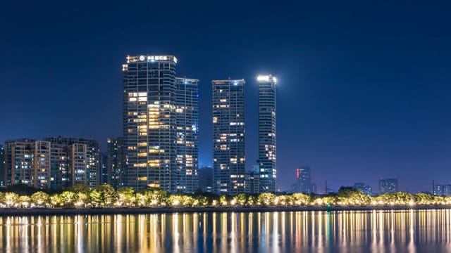 Stunning view of Guangzhou's illuminated skyline reflecting on the river at night.