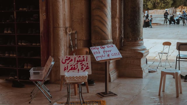 Signs for charity seeking help for Gaza at a historical site in Jerusalem.