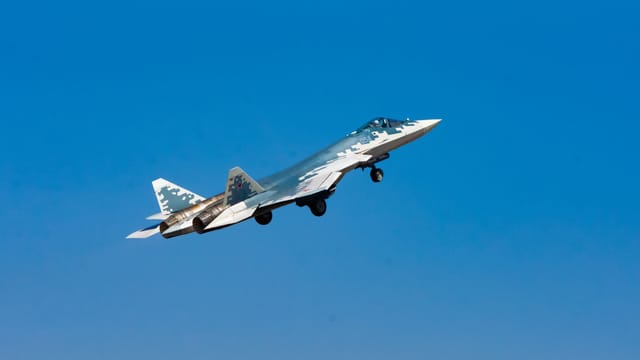 High-speed military jet aircraft soaring through the clear blue sky in Bengaluru.