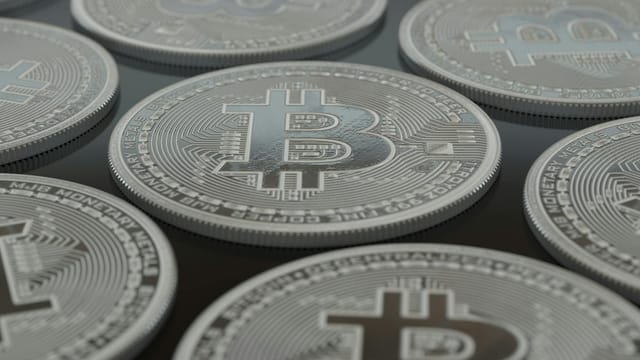Detailed close-up of silver Bitcoin coins showcasing digital currency concepts.