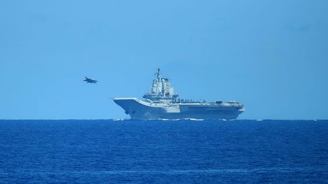 A PLAN Shenyang J-15 carrier-based fighter aircraft is taking off from Chinese aircraft carrier PLANS Liaoning (CV-16) 20220516