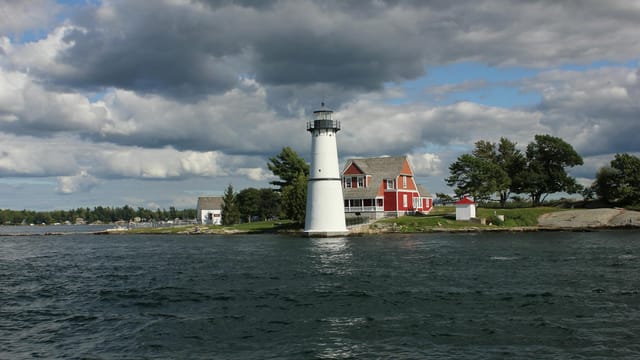 Picturesque view of Rock Island Lighthouse and its surroundings under a dramatic sky.