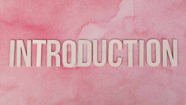 Wooden 'Introduction' text on a pink watercolor background, perfect for presentations.