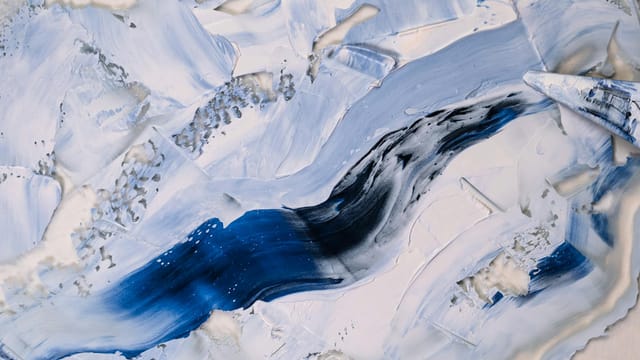 A dynamic abstract painting featuring blue and white textures, resembling Arctic landscapes.