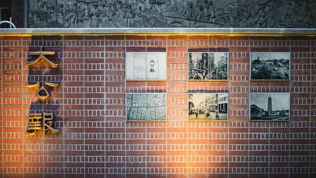 Intricate wall art depicting historical scenes in Guangzhou, China.