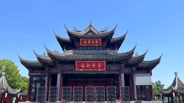 Beautiful traditional Chinese architecture of a temple in Suzhou, captured under a clear blue sky.