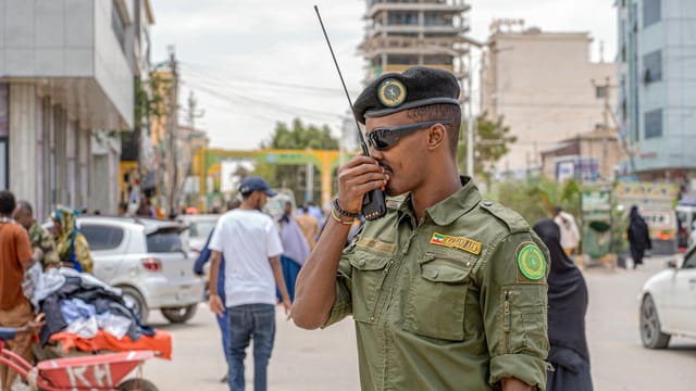 A military officer uses a radio in Hargeisa, Somalia, demonstrating peacekeeping efforts.