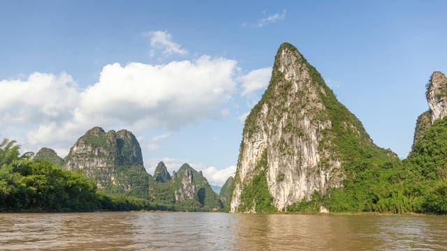 A breathtaking scenic view of karst mountains reflecting on the Li River in Yangshuo, Guangxi, China.
