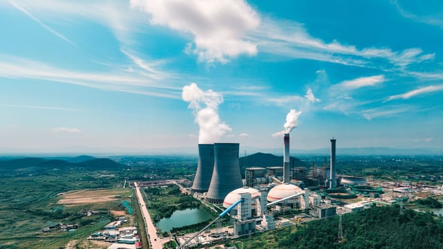 Aerial view of an industrial power plant near Jiujiang, showcasing infrastructure and landscape.