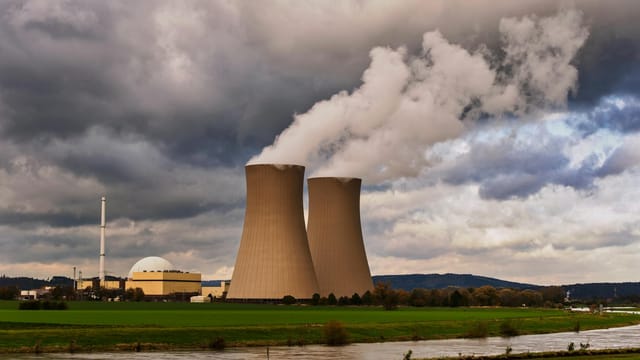 Scenic view of a nuclear power plant with cooling towers emitting steam in Hameln, Germany.