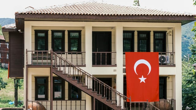 A charming traditional Turkish house displaying the national flag, symbolizing national pride.