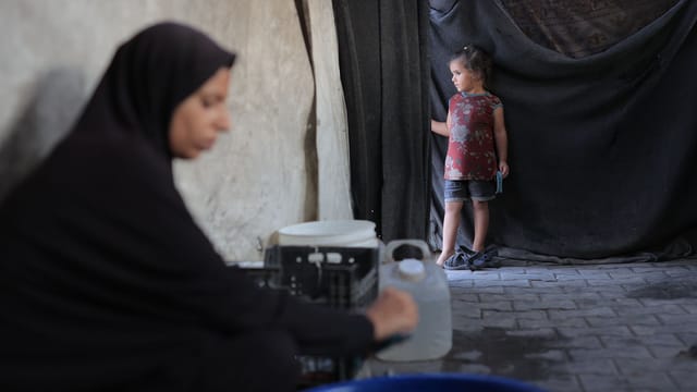 A thoughtful moment between a mother and child in Gaza. Life amidst challenging conditions.