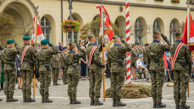 Polish soldiers in military uniforms at a formal parade in Wrocław, showcasing national pride and ceremonial display.